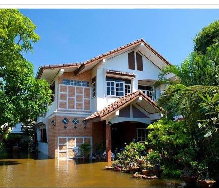 Picture of the outdoor of a home surrounded by floodwaters